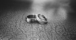 Elegant black and white close-up of wedding rings symbolizing love and commitment.