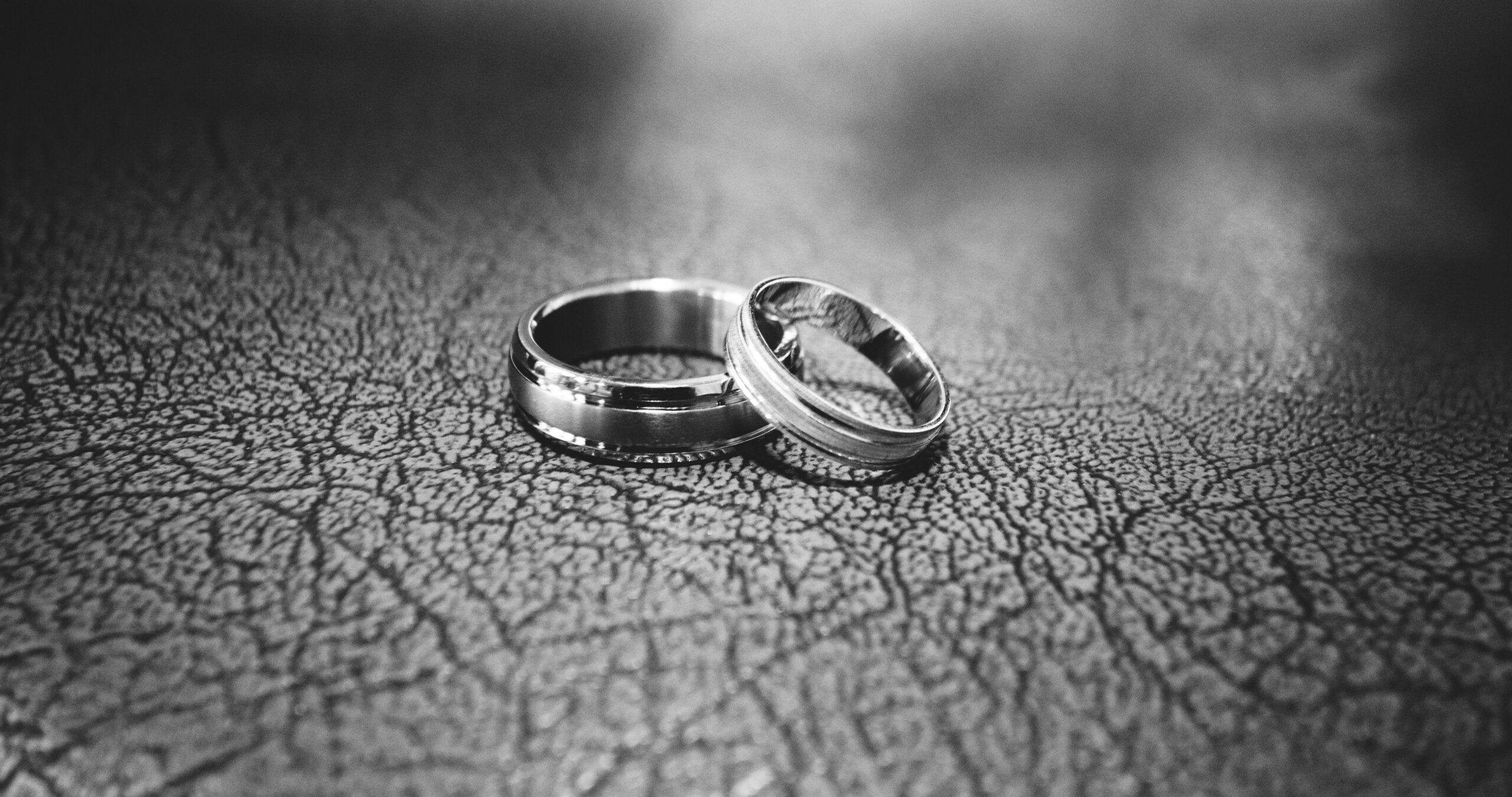 Elegant black and white close-up of wedding rings symbolizing love and commitment.